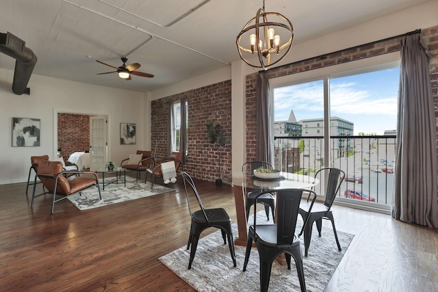 432 E Rich St Unit 4A, Columbus, OH 43215 - dining area with brick wall, a ceiling fan, wood finished floors, and a chandelier