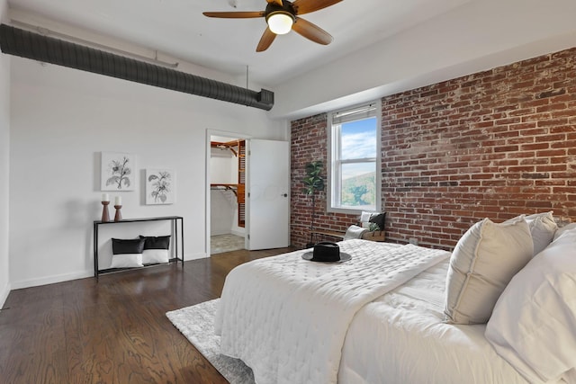 432 E Rich St Unit 4A, Columbus, OH 43215 - bedroom with brick wall, wood finished floors, ceiling fan, a closet, and a walk in closet