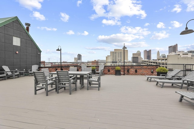 432 E Rich St Unit 4A, Columbus, OH 43215 - wooden deck with outdoor dining space and a view of skyline