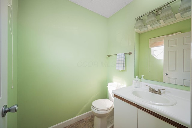 1845 Messner Dr Unit 57E, Hilliard, OH 43026 - half bath featuring toilet, vanity, and baseboards