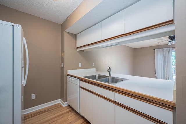 1845 Messner Dr Unit 57E, Hilliard, OH 43026 - kitchen with freestanding refrigerator, dishwasher, a sink, light wood-type flooring, and white cabinets
