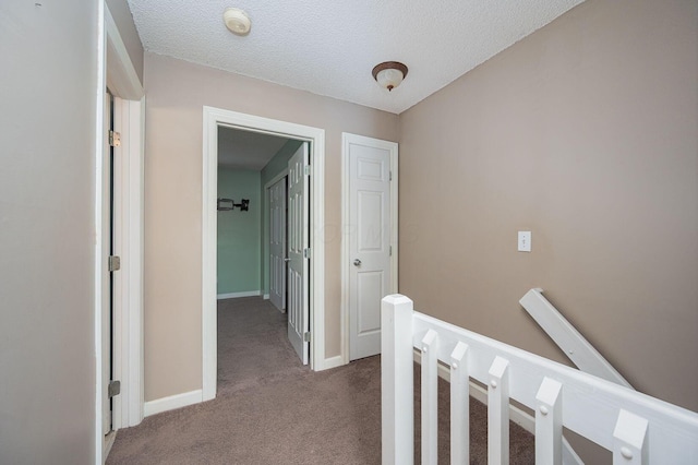 1845 Messner Dr Unit 57E, Hilliard, OH 43026 - hall with carpet flooring, an upstairs landing, baseboards, and a textured ceiling
