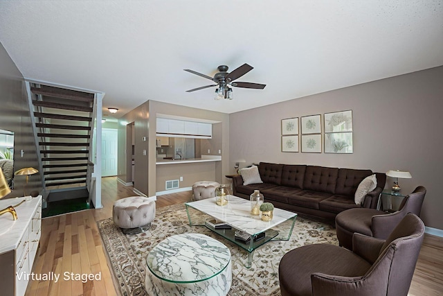 1845 Messner Dr Unit 57E, Hilliard, OH 43026 - living room featuring light wood-style floors, a ceiling fan, and stairway