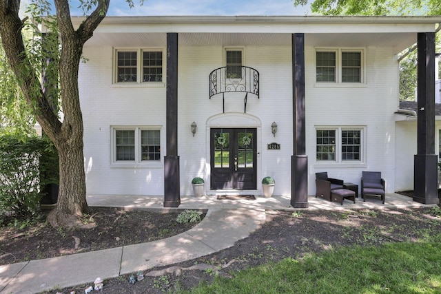 4286 Evansdale Rd, Columbus, OH 43214 - view of front of house featuring brick siding, french doors, and covered porch