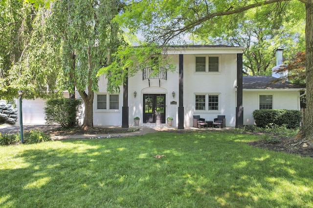 4286 Evansdale Rd, Columbus, OH 43214 - back of property with french doors, a lawn, an attached garage, brick siding, and a chimney