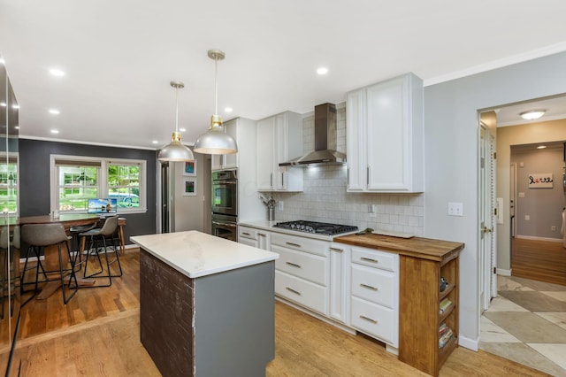 4286 Evansdale Rd, Columbus, OH 43214 - kitchen with wall chimney exhaust hood, stainless steel appliances, backsplash, a center island, and ornamental molding