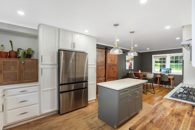 4286 Evansdale Rd, Columbus, OH 43214 - kitchen featuring appliances with stainless steel finishes, gray cabinets, a barn door, light wood-style flooring, and recessed lighting