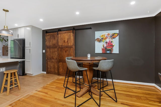 4286 Evansdale Rd, Columbus, OH 43214 - dining room featuring a barn door, light wood finished floors, and recessed lighting