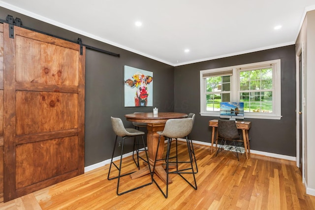 4286 Evansdale Rd, Columbus, OH 43214 - dining space with a barn door, light wood-type flooring, crown molding, and recessed lighting