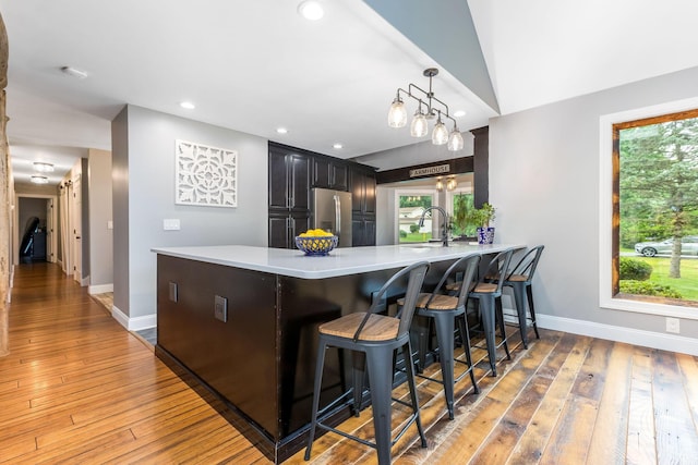 170 Nantucket Ave, Pickerington, OH 43147 - kitchen with stainless steel fridge, light wood-style flooring, light countertops, a peninsula, and recessed lighting