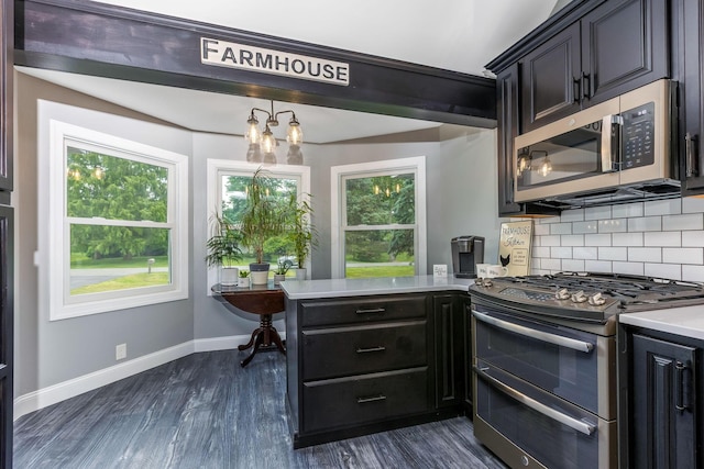 170 Nantucket Ave, Pickerington, OH 43147 - kitchen featuring appliances with stainless steel finishes, decorative backsplash, a peninsula, dark wood-style floors, and light countertops