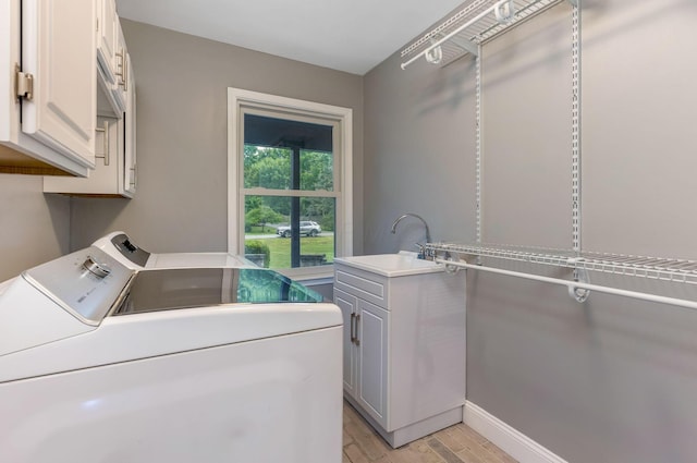 170 Nantucket Ave, Pickerington, OH 43147 - washroom featuring cabinet space, washer and dryer, and light wood finished floors