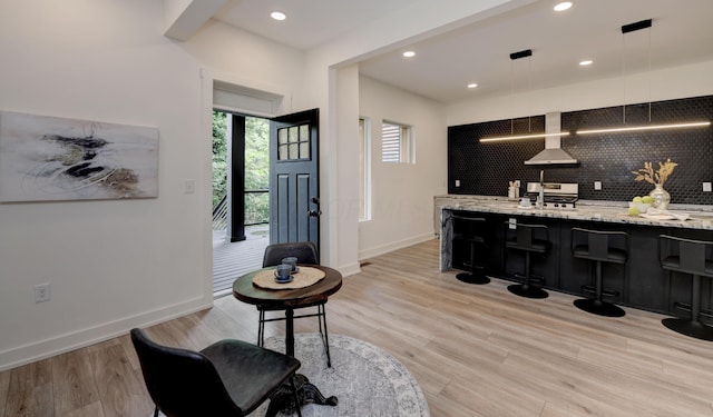 39 Auburn Ave, Columbus, OH 43205 - bar area featuring decorative backsplash, recessed lighting, baseboards, light wood-style flooring, and pendant lighting