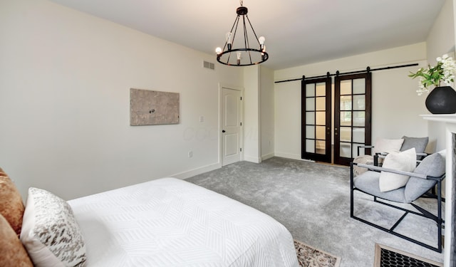 39 Auburn Ave, Columbus, OH 43205 - carpeted bedroom featuring a barn door, a chandelier, and baseboards