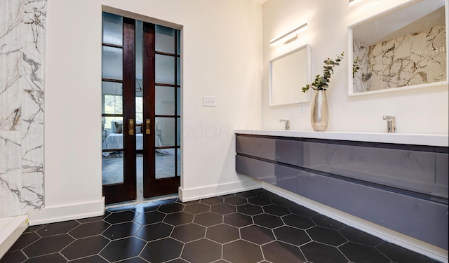 39 Auburn Ave, Columbus, OH 43205 - full bathroom with double vanity, french doors, baseboards, and tile patterned flooring