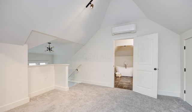 39 Auburn Ave, Columbus, OH 43205 - additional living space featuring an AC wall unit, carpet floors, vaulted ceiling, and baseboards