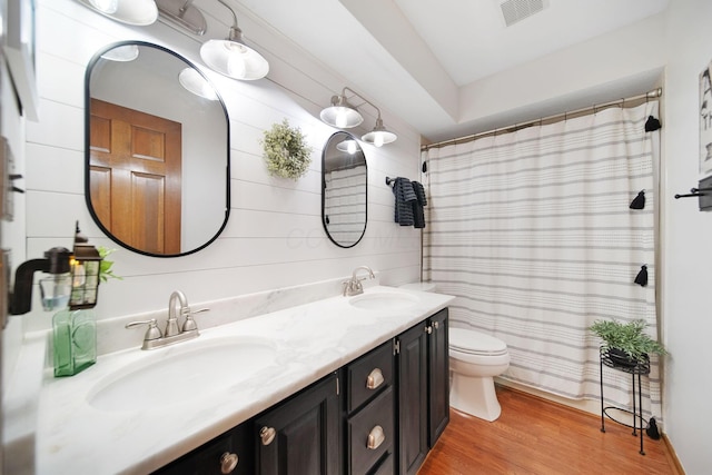 3040 Atoll Dr, Lewis Center, OH 43035 - full bathroom featuring double vanity, wood finished floors, and a shower with shower curtain