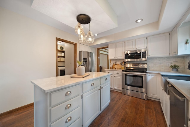 3040 Atoll Dr, Lewis Center, OH 43035 - kitchen featuring stainless steel appliances, white cabinetry, a center island, backsplash, and recessed lighting
