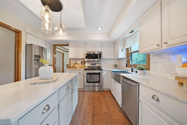 3040 Atoll Dr, Lewis Center, OH 43035 - kitchen with stainless steel appliances, white cabinets, light stone counters, tasteful backsplash, and dark wood-type flooring
