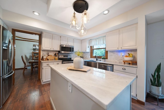 3040 Atoll Dr, Lewis Center, OH 43035 - kitchen with stainless steel appliances, white cabinets, decorative backsplash, a center island, and recessed lighting