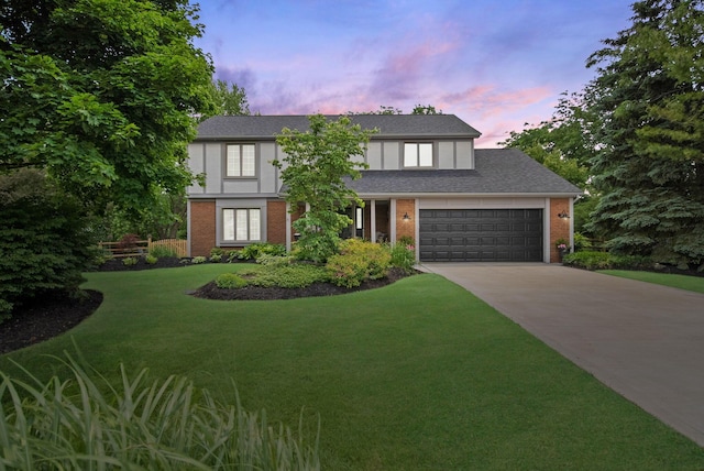3040 Atoll Dr, Lewis Center, OH 43035 - tudor-style house featuring brick siding, concrete driveway, a yard, a garage, and roof with shingles