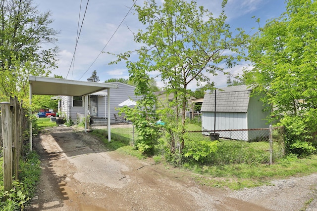 3216 Howey Rd, Columbus, OH 43224 - view of yard featuring driveway and a carport