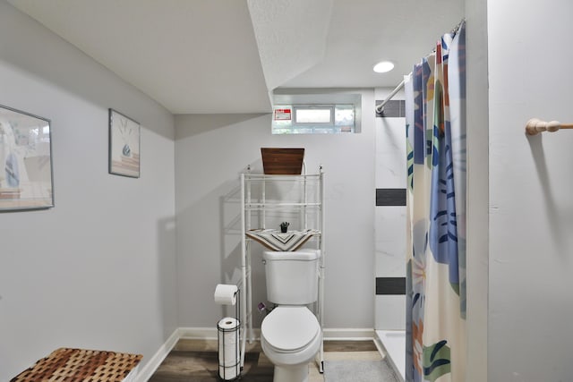 3216 Howey Rd, Columbus, OH 43224 - bathroom with toilet, baseboards, a shower with shower curtain, and wood finished floors