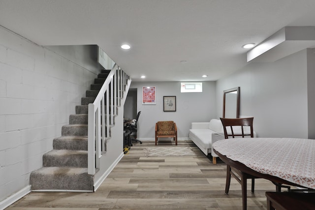 3216 Howey Rd, Columbus, OH 43224 - dining space with recessed lighting, stairs, light wood-type flooring, baseboards, and concrete block wall