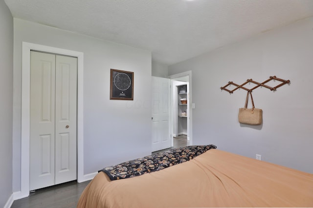 3216 Howey Rd, Columbus, OH 43224 - bedroom with a closet, dark wood-style flooring, and baseboards