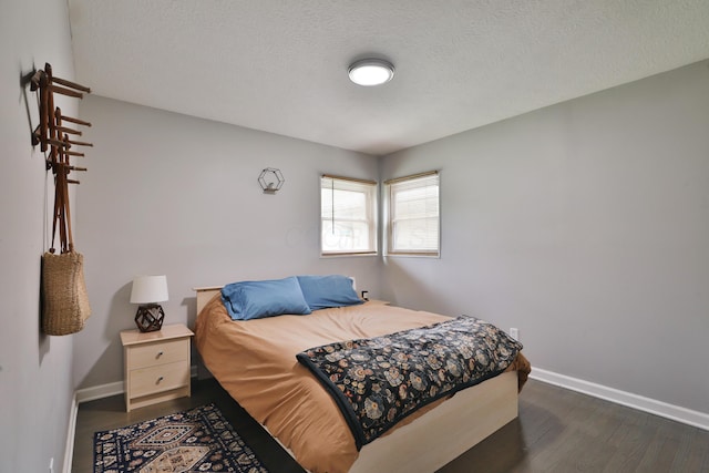 3216 Howey Rd, Columbus, OH 43224 - bedroom with dark wood-style floors, baseboards, and a textured ceiling
