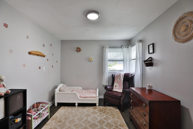 3216 Howey Rd, Columbus, OH 43224 - bedroom featuring wood finished floors, baseboards, and a textured ceiling