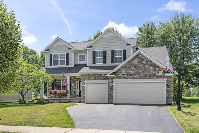 1026 Balmoral Dr, Delaware, OH 43015 - view of front of property featuring asphalt driveway, stone siding, roof with shingles, and a front lawn