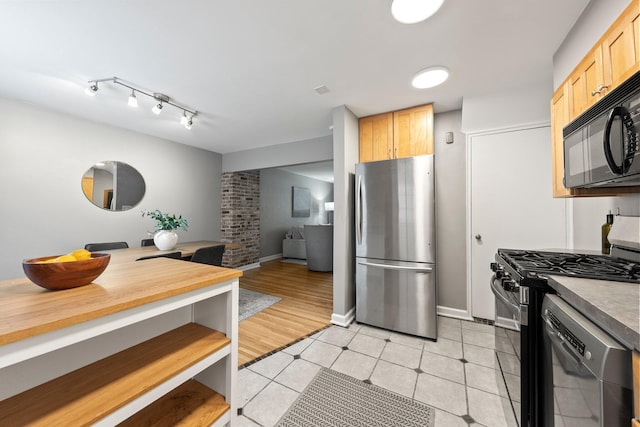 1831 NW Blvd Unit B, Columbus, OH 43212 - kitchen with stainless steel appliances, light brown cabinets, light tile patterned floors, and open floor plan