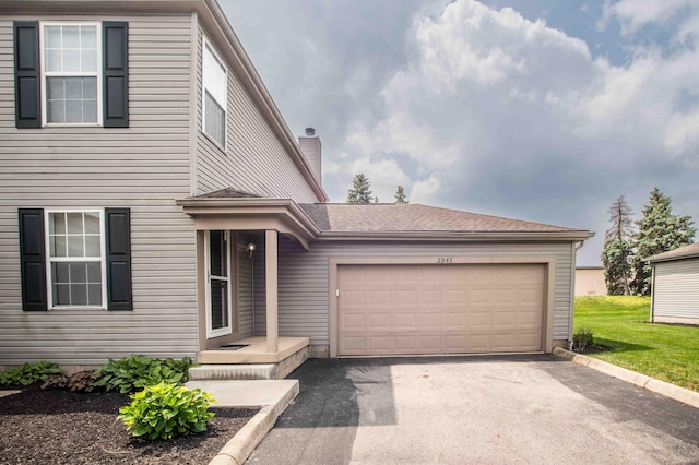 2043 Coleman Dr Unit 6F, Columbus, OH 43235 - view of front of property with a garage, driveway, and a chimney