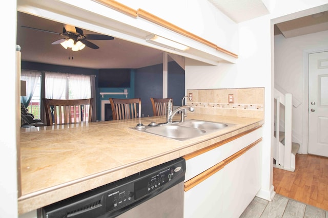 2043 Coleman Dr Unit 6F, Columbus, OH 43235 - kitchen featuring stainless steel dishwasher, a sink, a ceiling fan, white cabinets, and backsplash