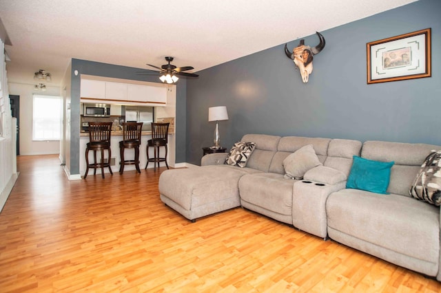 2043 Coleman Dr Unit 6F, Columbus, OH 43235 - living room with light wood finished floors, ceiling fan, and baseboards