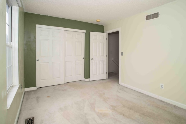 2043 Coleman Dr Unit 6F, Columbus, OH 43235 - unfurnished bedroom with carpet flooring, baseboards, a closet, and a textured ceiling