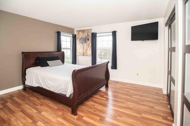 2043 Coleman Dr Unit 6F, Columbus, OH 43235 - bedroom with light wood-style floors, baseboards, and a textured ceiling