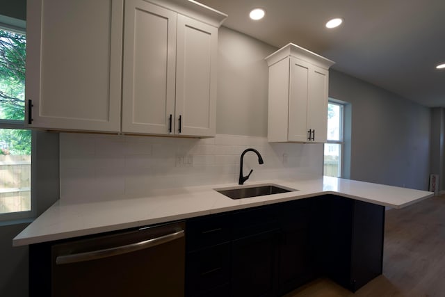 1275 Wager St, Columbus, OH 43206 - kitchen featuring dishwasher, backsplash, white cabinetry, light stone counters, and recessed lighting