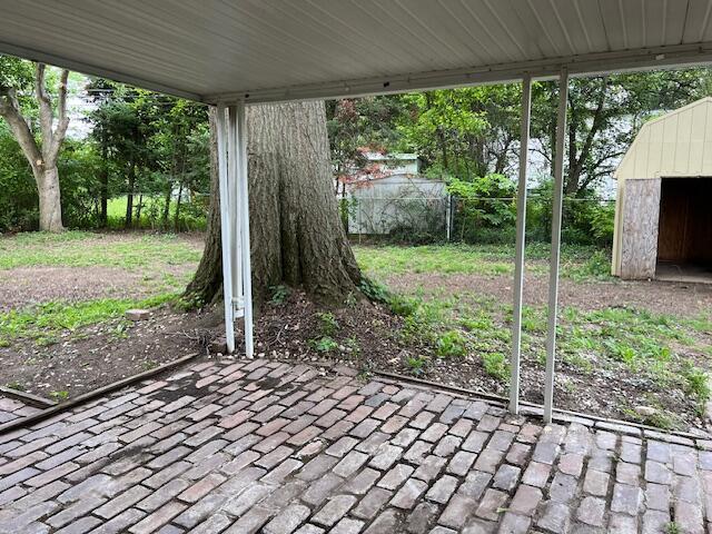 1416 Benson Dr, Columbus, OH 43227 - view of patio with a storage unit