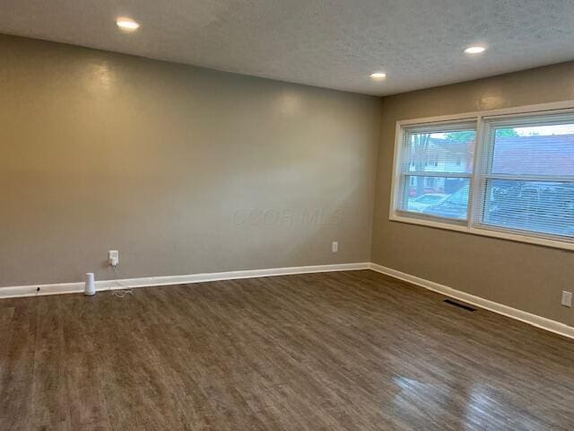 1416 Benson Dr, Columbus, OH 43227 - empty room with dark wood-type flooring, recessed lighting, and a textured ceiling