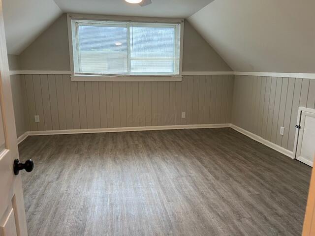 1416 Benson Dr, Columbus, OH 43227 - bonus room with wood finished floors, lofted ceiling, wainscoting, and wooden walls