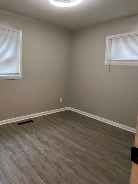1416 Benson Dr, Columbus, OH 43227 - spare room featuring dark wood-style floors and baseboards