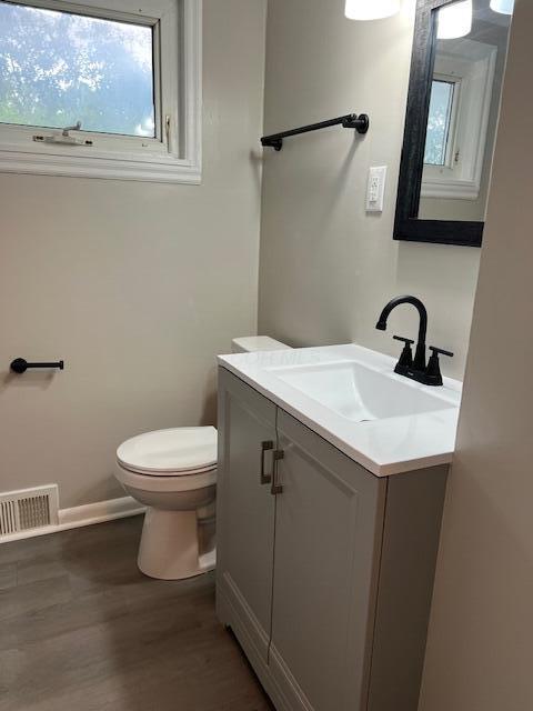 1416 Benson Dr, Columbus, OH 43227 - half bath featuring vanity and wood finished floors