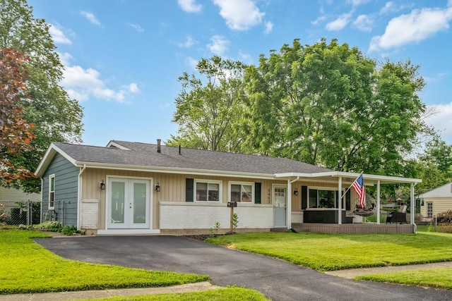 5452 Roche Ct W, Columbus, OH 43229 - single story home featuring french doors, a front lawn, a shingled roof, and brick siding