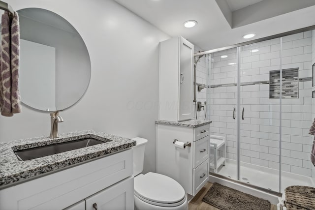 5452 Roche Ct W, Columbus, OH 43229 - full bathroom featuring vanity, a shower stall, wood finished floors, and recessed lighting