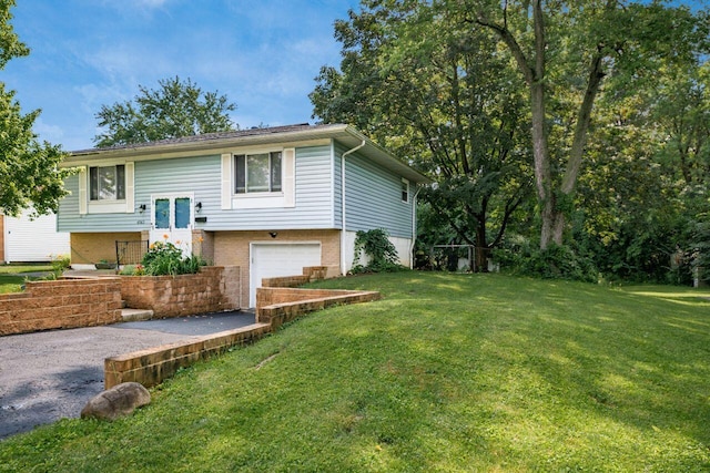 6563 Karl Rd, Columbus, OH 43229 - raised ranch with a garage, driveway, a front lawn, and brick siding