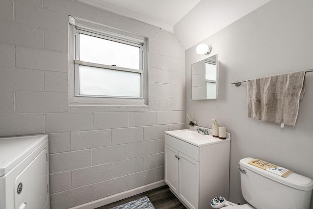 6563 Karl Rd, Columbus, OH 43229 - bathroom with washer / dryer, vanity, and wood finished floors