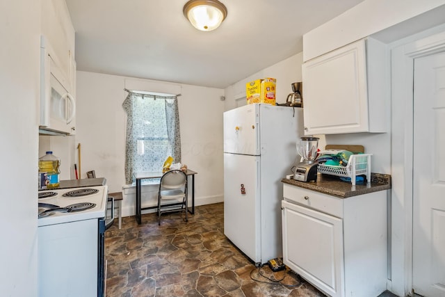972 E 12th Ave, Columbus, OH 43211 - kitchen with white appliances, white cabinetry, dark stone finish floors, and dark countertops