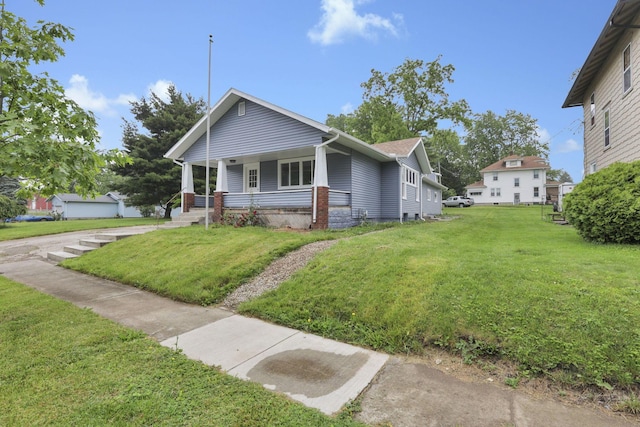 704 N Detroit St, Bellefontaine, OH 43311 - bungalow featuring a porch and a front yard